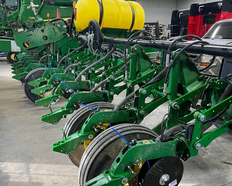 Row units with disc openers and gauge wheels lined up on a shop floor