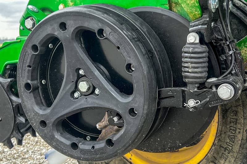 Close-up of a planter gauge wheel and arm