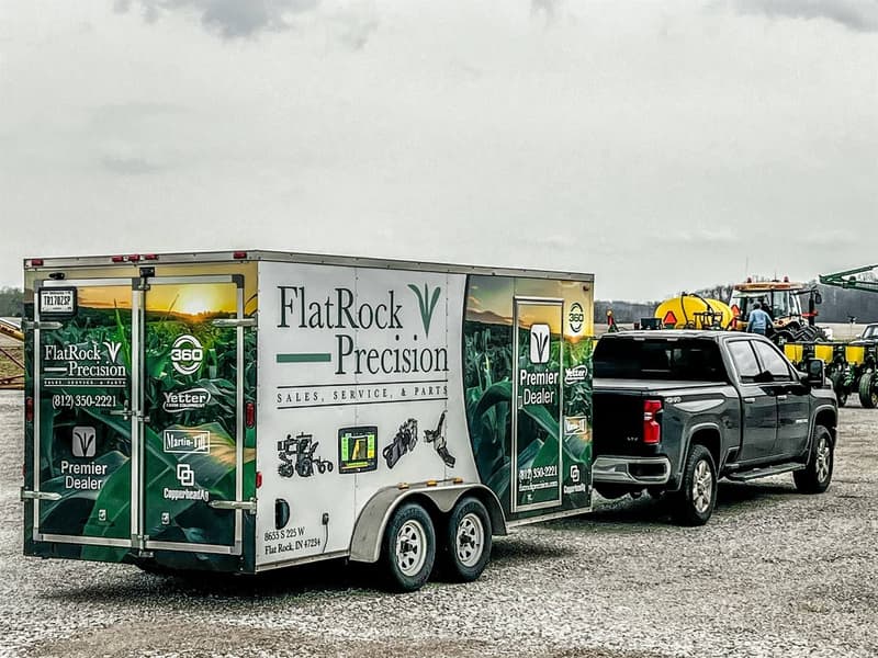 Flat Rock Precision service trailer and pickup on gravel in front of a planter