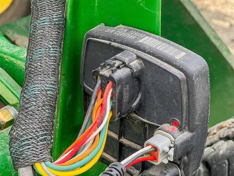 Wiring harness and connector on a row unit.