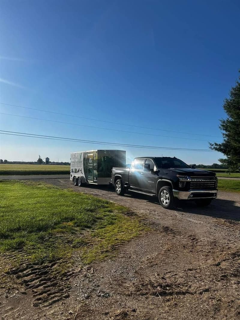 Pickup and service trailer on a farm lane