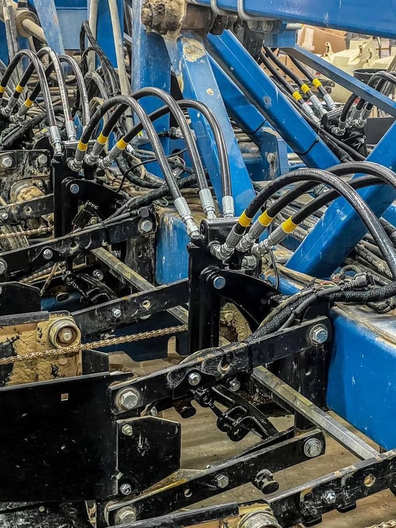 Hydraulic lines routed and clamped, row by row.